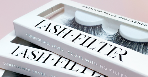 Close-up of a false strip lash box with fluffy lashes visible inside